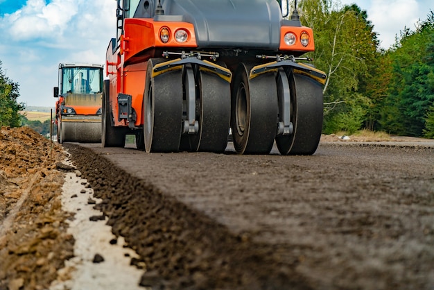 Large view on the road rollers working on the new road construction site