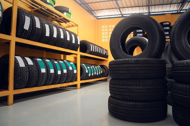 Photo large warehouse of car tires, rack with customer car tires in warehouse of a tire dealer