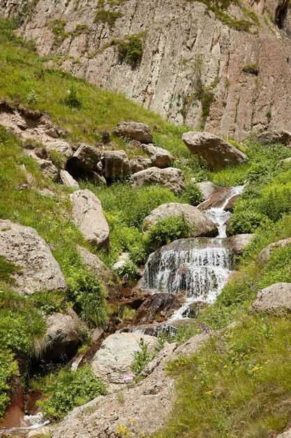 写真 岩の真ん中に大きな 高い山と石の間で流れる水