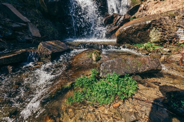 A large waterfall over a rocky cliff