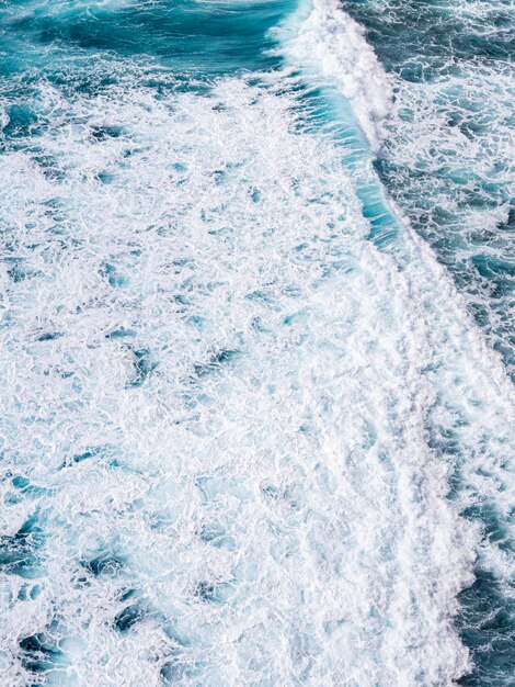 A large wave is breaking on the ocean.