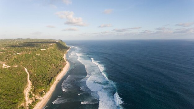 Large waves of turquoise water crushing on a beach melasti baliindonesia travel concept