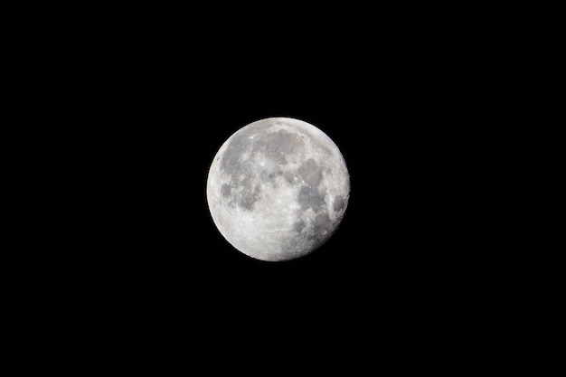 Large white full moon on black night sky