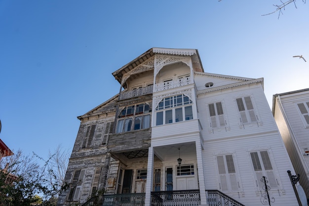 A large white house with a blue sky in the background