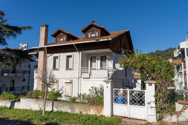 A large white house with a white fence and a white roof