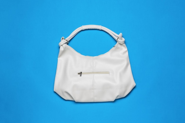 A large white leather bag on a blue background