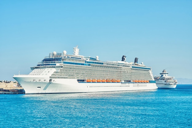 Large white tourist cruise ship on boundless blue rippling sea near Rhodes island in Greece