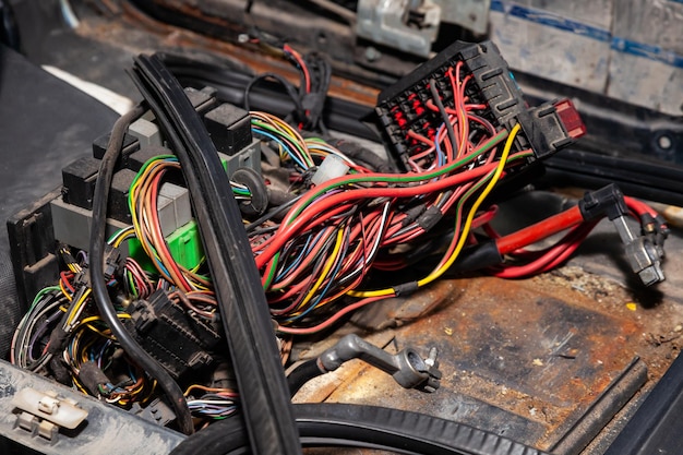 Large wide cable with multicolored red and green wires and connectors and terminals in the wiring repair shop and electricians for connecting and transmitting electricity and digital signals