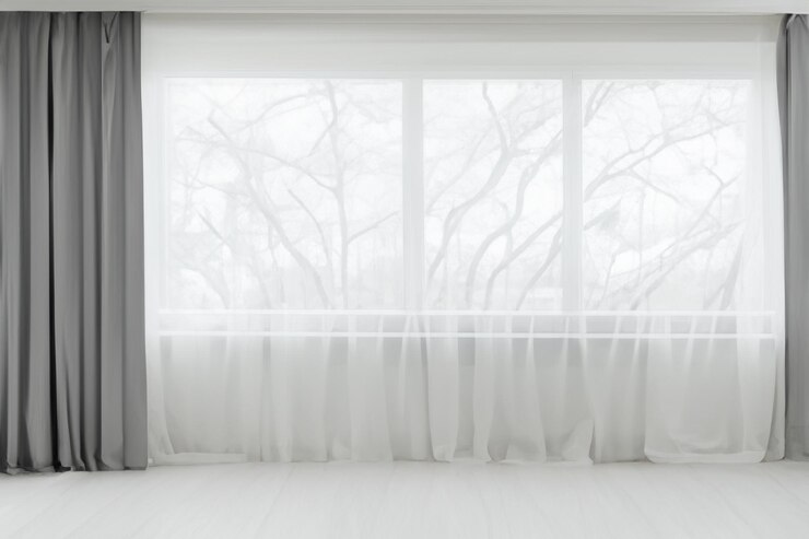 a large window with a white curtain that says  trees