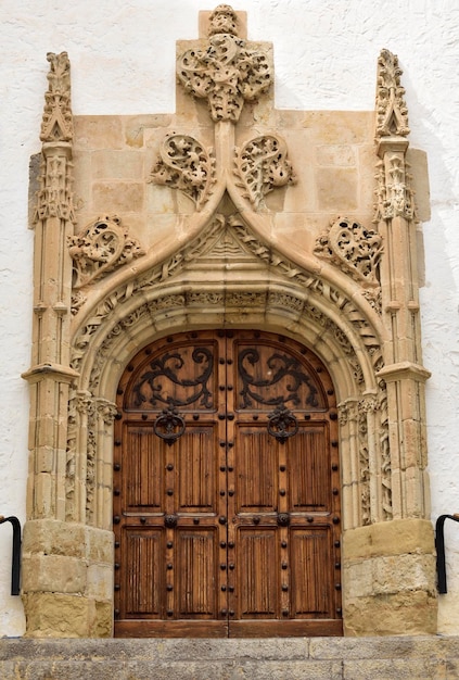 A large wooden door with a cross on it