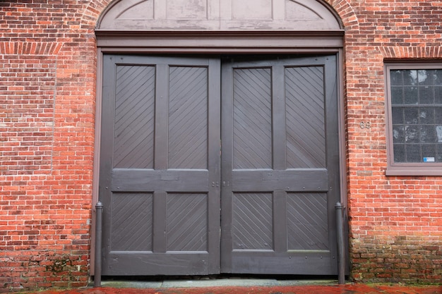 A large wooden door with a dark door.