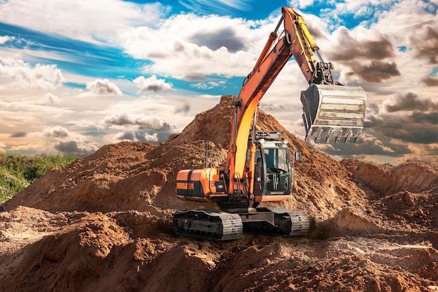 A large yellow crawler excavator moving stone or soil in a quarry