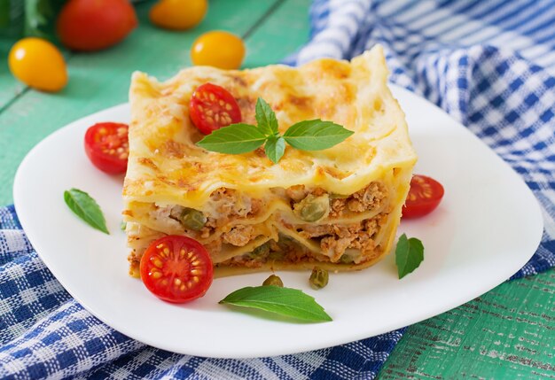 Lasagna with minced meat, green peas and sauce