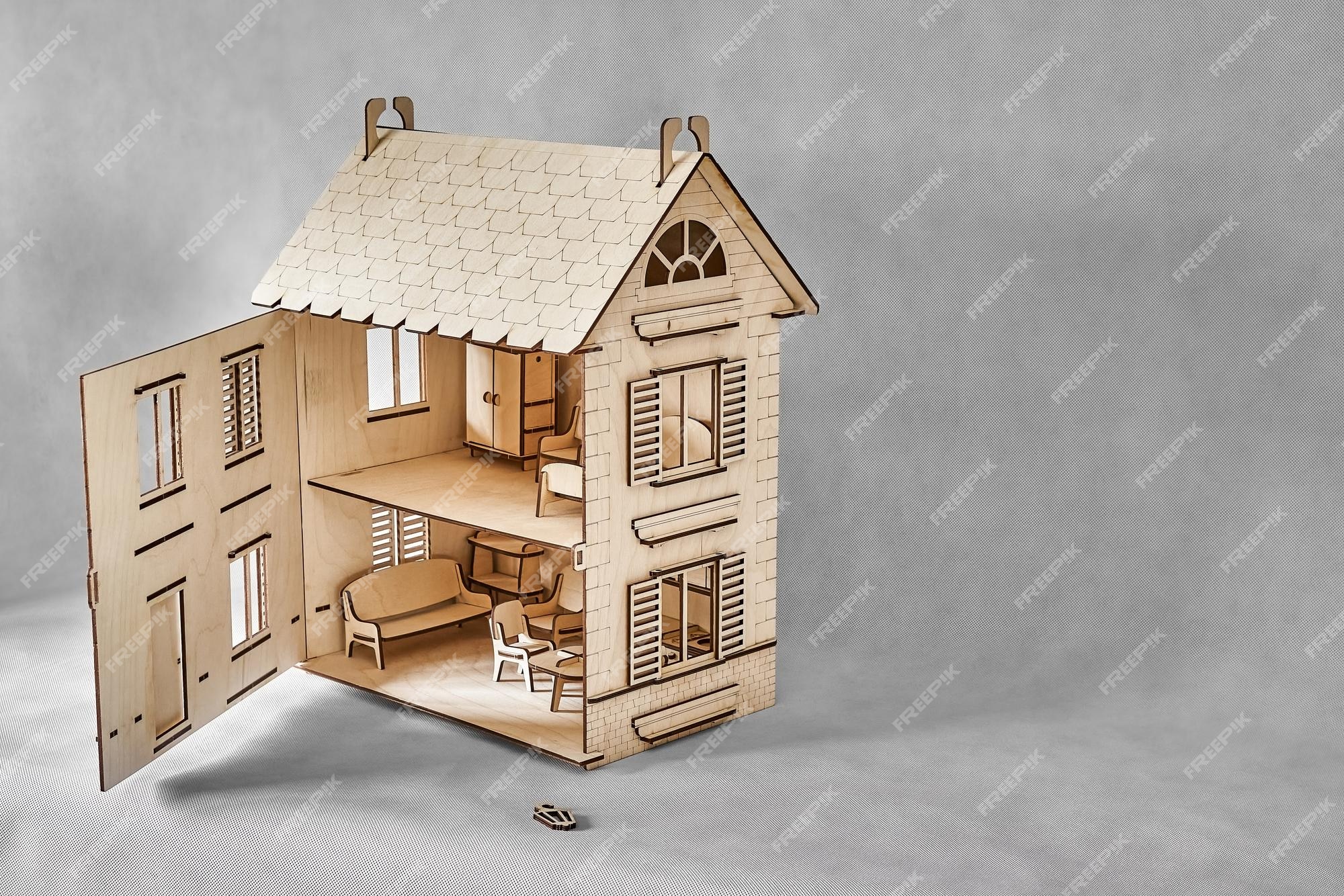 Premium Photo  Laser cut doll house with small furniture made of plywood  details with open wall on light grey