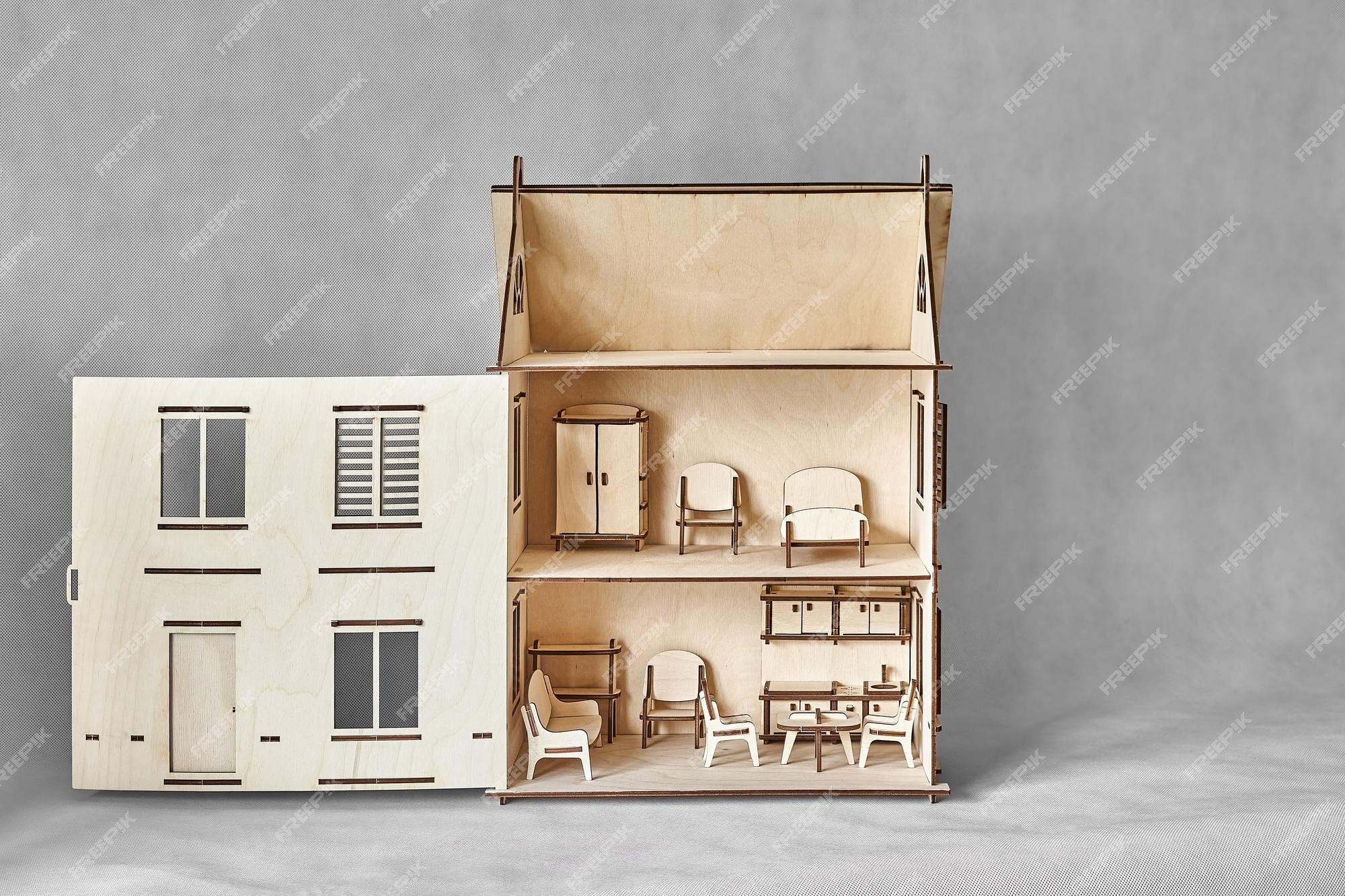 Premium Photo  Laser cut doll house with small furniture made of plywood  details with open wall on light grey