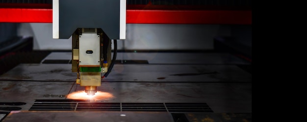 Laser cut head machine while cutting the sheet metal with the
sparking light in factorycopy space