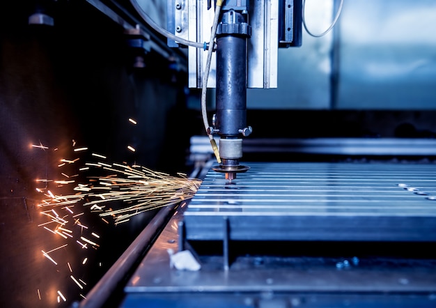 The laser cutting machine cutting the holes on pipes.