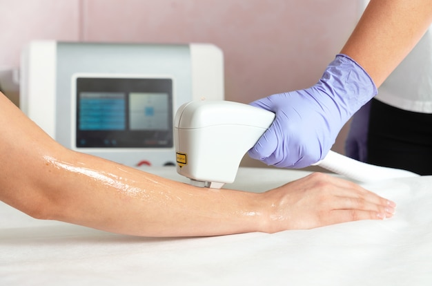 Premium Photo | Laser hair removal of hands in a beauty salon. hand hair removal procedure using laser hair removal technology. Premium Photo | Laser hair removal of hands in a beauty salon. hand hair removal procedure using laser hair removal technology.