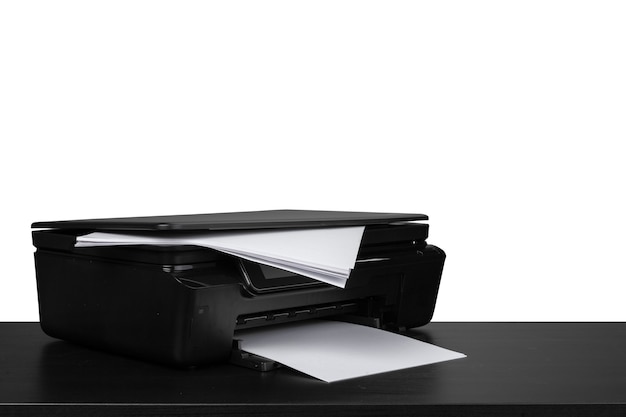 Laser home printer on table against white backgorund