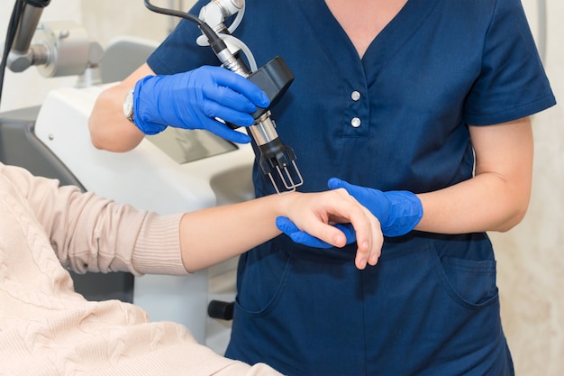 Laser huidverjonging op vrouwelijke armen en handen bij schoonheidskliniek. Cosmetologie en SPA concept.