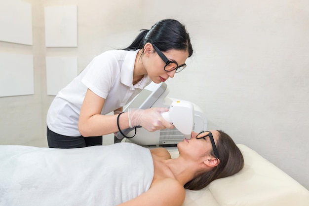 Laser removal Hair unwanted on face young woman Health and beauty concept young woman getting laser hair removal treatment on face in salon