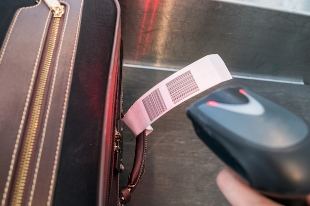 Laser scanner barcode reader scanning for loading luggage bag in the airport