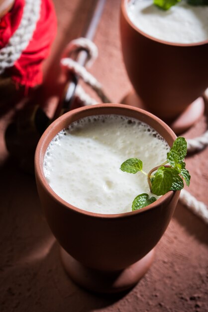 Lassie or lassi in terracotta glass - Lassi is an Authentic Indian cold drink made up of curd and milk and sugar