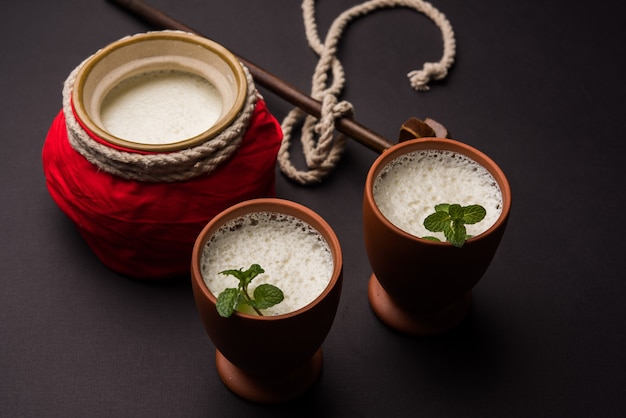 Lassie or lassi in terracotta glass - Lassi is an Authentic Indian cold drink made up of curd and milk and sugar