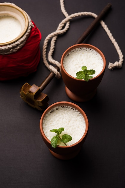 Lassie or lassi in terracotta glass - Lassi is an Authentic Indian cold drink made up of curd and milk and sugar