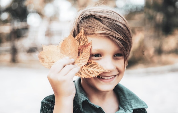 Last days of warm weather must be seen off with a smile on his face Happy child at the autumn fair Little boy advertises natural products The boy advertises children's clothes for the autumn