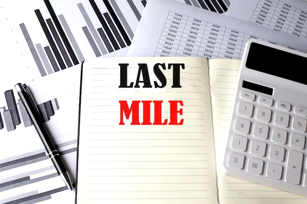 LAST MILE text written on a notebook on chart and diagram