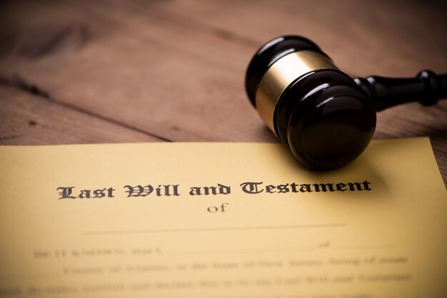 Photo last will and testament form with gavel. decision, financial close up