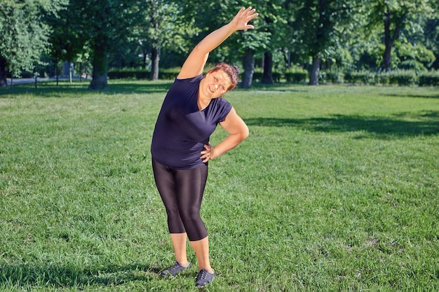 Lateral flexion for an one obese mature woman or fitness exercise side bends