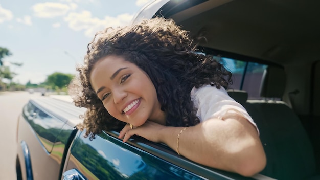 Latijnse vrouw in autoraam. Auto reis. Krullend haar in de wind. Meisje kijkt uit autoraam.