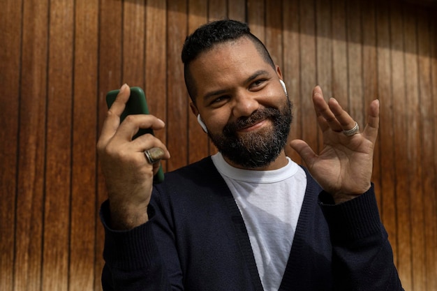 Latin American adult male greeting during a video call