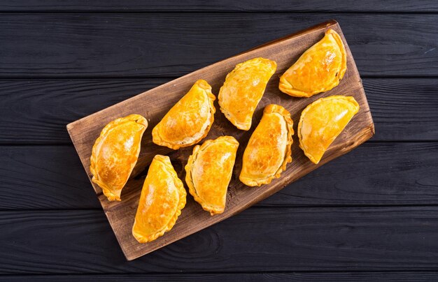 Photo latin american baked beef empanadas with sauces food background