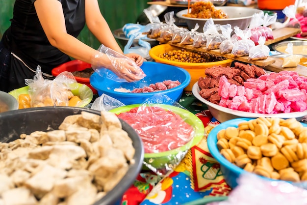 Latin American Candies Sorted by Hand in Vibrant Market