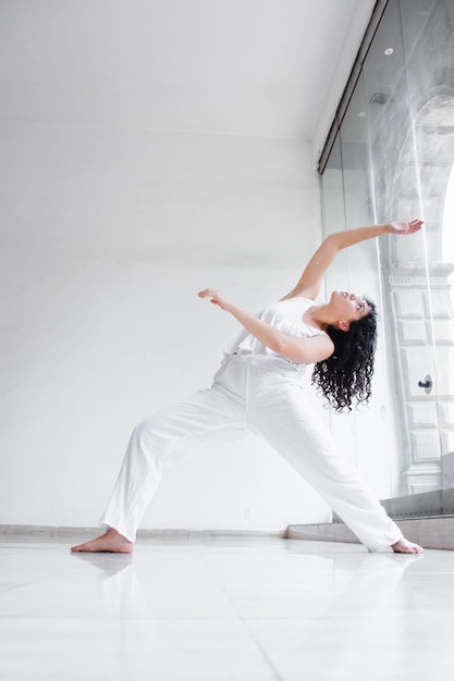 Latin american dancer performing at white studio