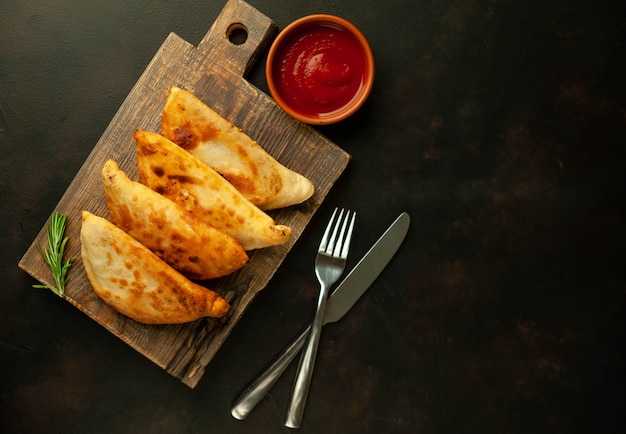 Latin American fried empanadas with tomato sauce   with copy space for your text