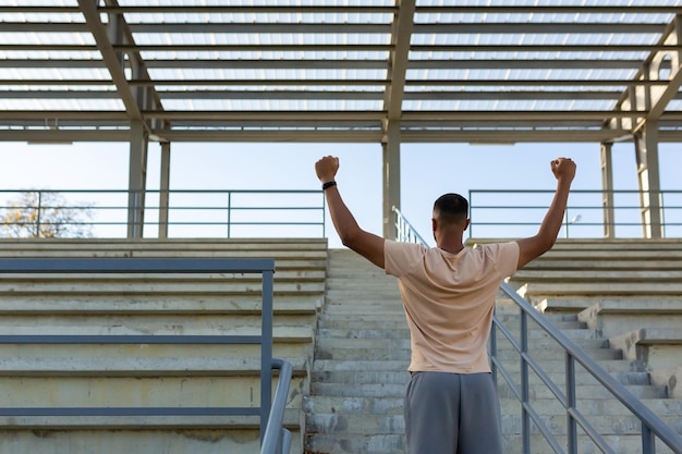 Latin american male athlete happy with training results celebrating successful sport achievement