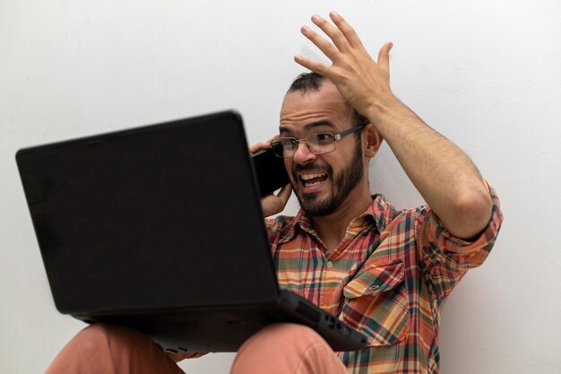 Latin American man with his laptop computer is a programmer and specializes in web development