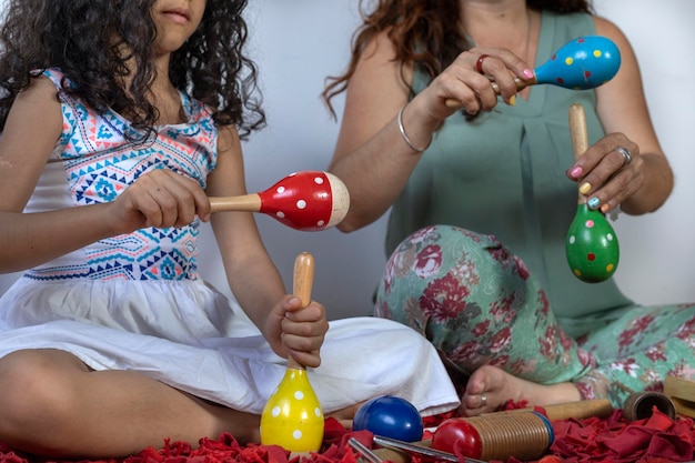 Latin American music teacher giving rhythmic music lessons with percussion instruments