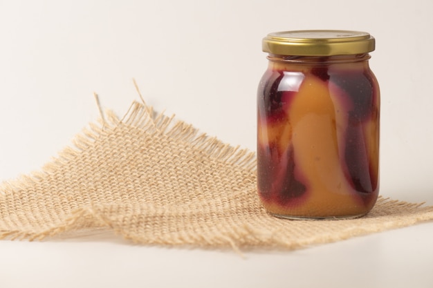 Latin American sweet caramel-like Manjar or Dulce de leche  with strawberry. Isolated on white background..