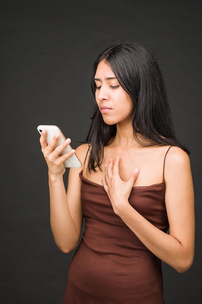 Latin american woman call frustrated trouble with anxiety on cellphone problem black background