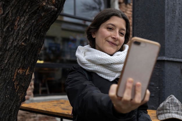 Latin American woman with cell phone on the streets of Buenos Aires