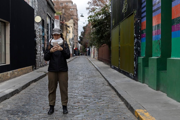 Latin American woman with cell phone on the streets of Buenos Aires