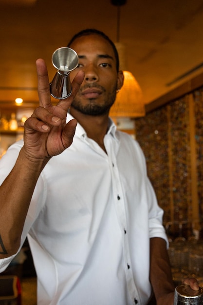 Latin bartender practising some cocktail movements