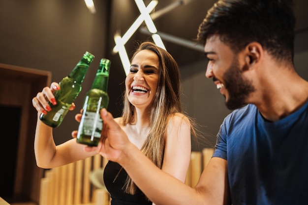 Latin couple drinking alcohol at the bar