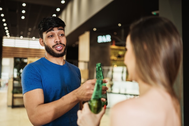 Latin couple drinking alcohol at the bar