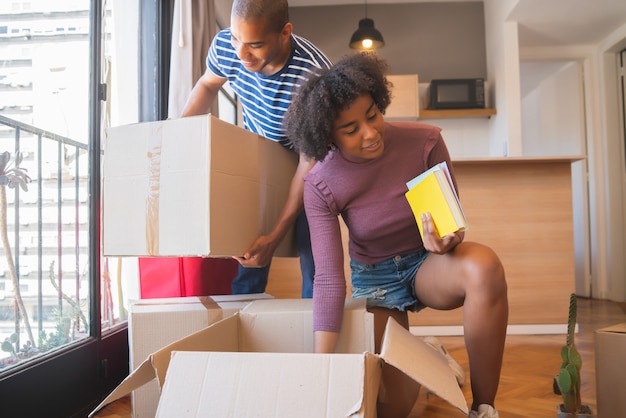 Latin couple unpacking at their new house.